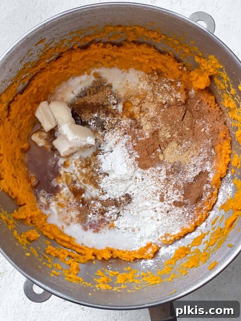 Creamy Vegan Sweet Potato Dream 10 The various filling ingredients added to the bowl of mashed sweet potatoes, ready for mixing.