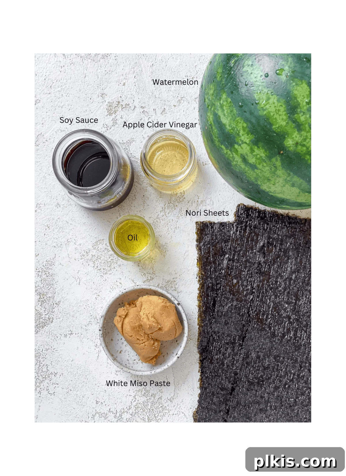 Watermelon Tuna: Sashimi and Steaks 3 All six key ingredients for making Watermelon Tuna, including sliced watermelon, nori sheets, soy sauce, oil, apple cider vinegar, and miso paste, neatly arranged on a white surface.