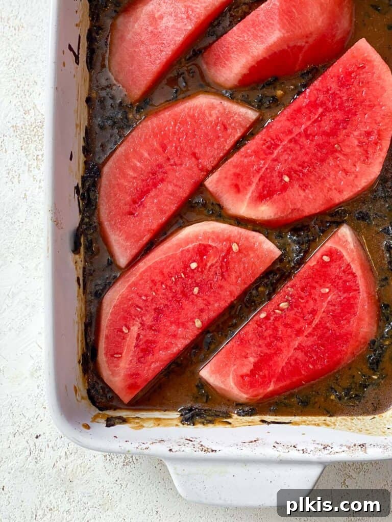 Watermelon Tuna: Sashimi and Steaks 6 Process shot showing the marinated watermelon slices neatly arranged on a baking dish, ready for baking. Each slice is evenly coated with the savory marinade.