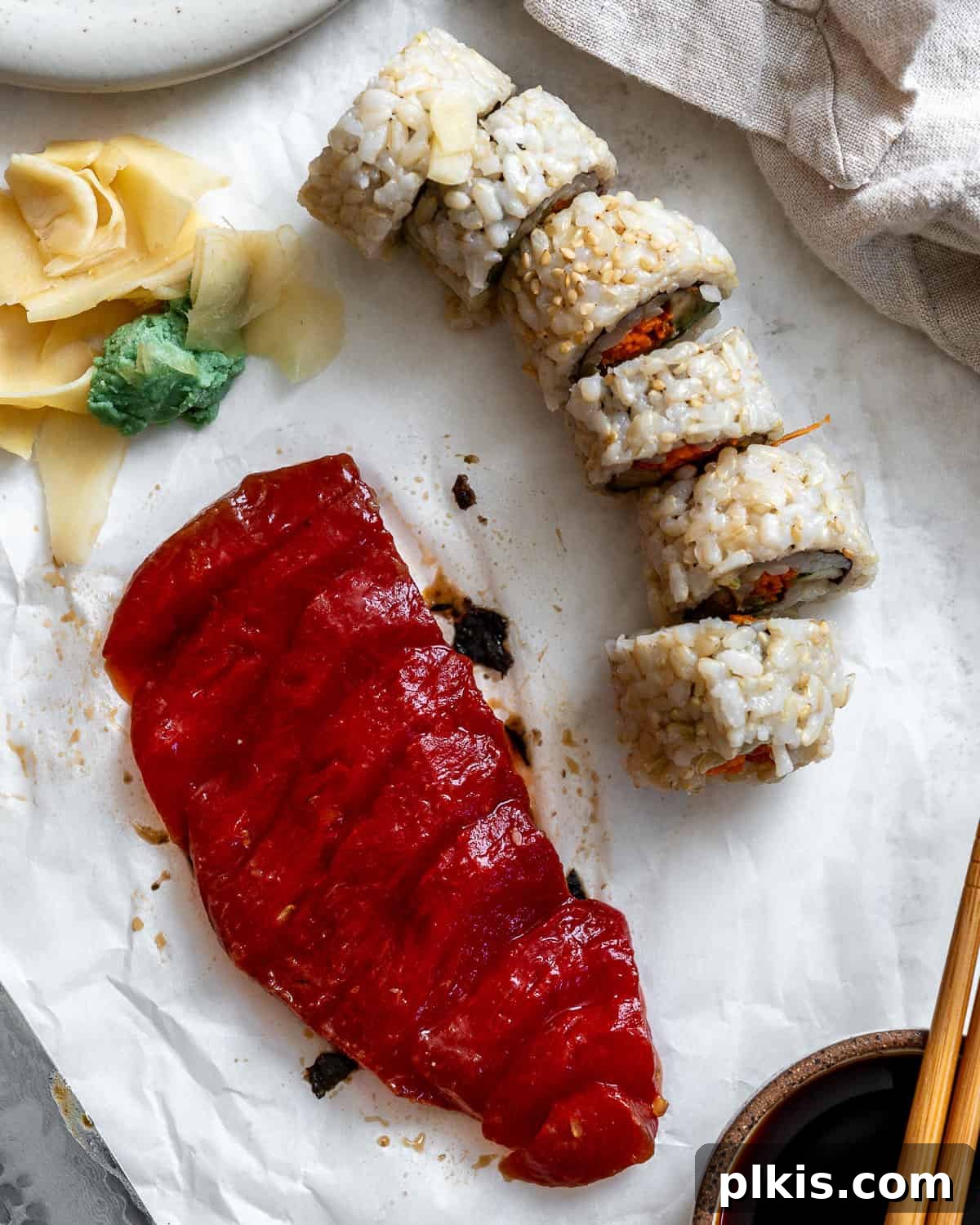 Watermelon Tuna: Sashimi and Steaks 8 Beautifully prepared Watermelon Tuna sashimi and steaks, garnished and artfully arranged on a pristine white surface, highlighting its vibrant color and appealing texture.