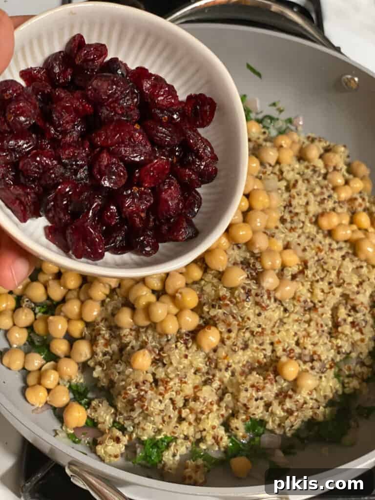 Hearty Vegan Quinoa Stuffed Acorn Squash 11 process shot of beans being added to pan