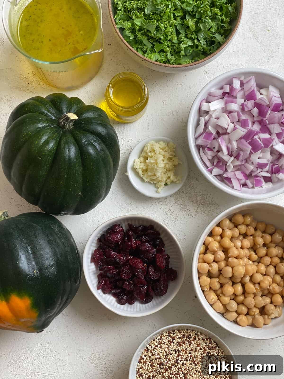 ingredients for Vegan Stuffed Acorn Squash [With Quinoa] measured out against a white surface