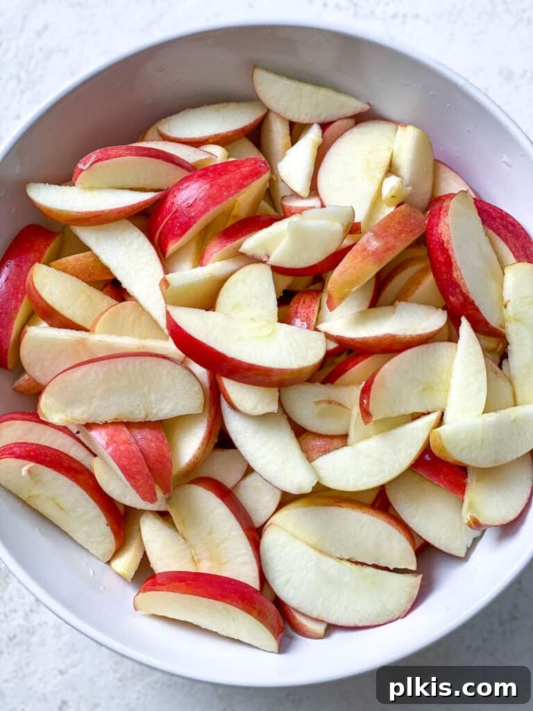 Cozy Spiced Apple Warmer 4 Sliced apples in a bowl, ready for cooking.