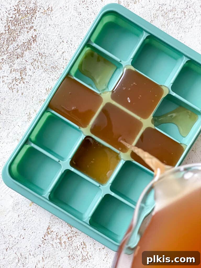 Frozen Apple Cider Delight 4 Process shot of pouring apple cider mixture into ice cube trays to freeze.