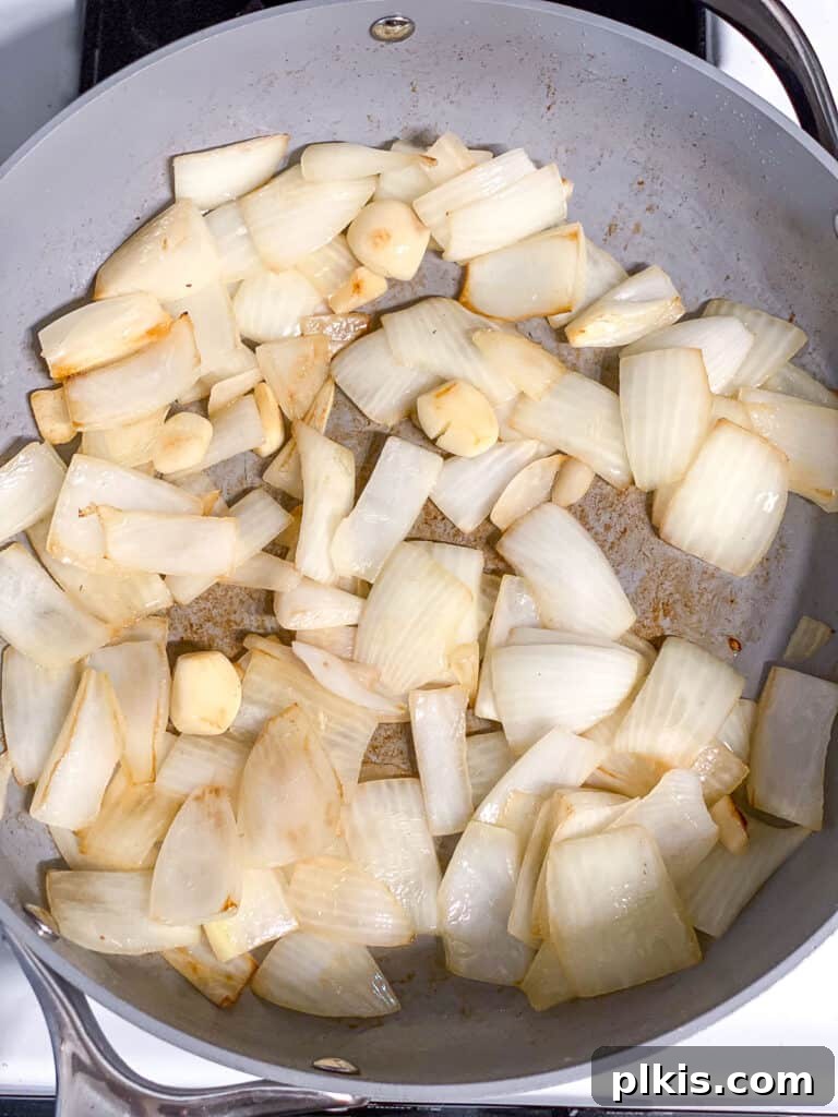 Velvety Pumpkin Pasta 5 process shot showing onions and garlic cooked in pan, ready for the next step