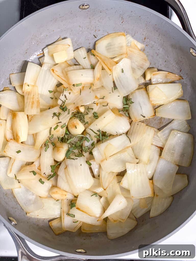 Velvety Pumpkin Pasta 6 process shot showing sage added to pan with cooked onions and garlic