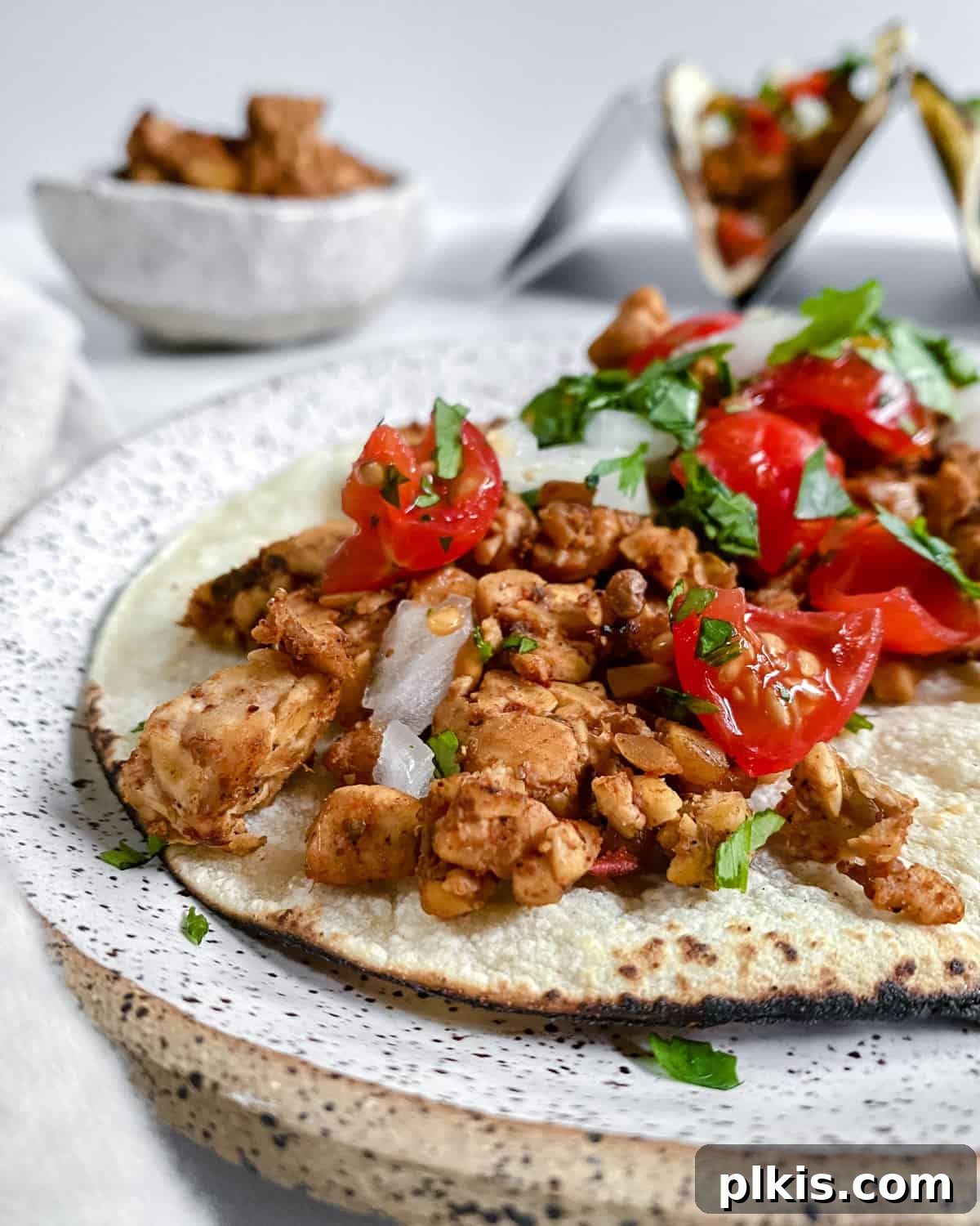 finished Chipotle Lime Street Style Tacos on a white plate, close-up with fresh toppings and lime wedges