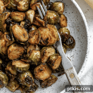 Completed caramelized Brussels sprouts on a plate, gleaming with a delicious glaze, ready to be served.