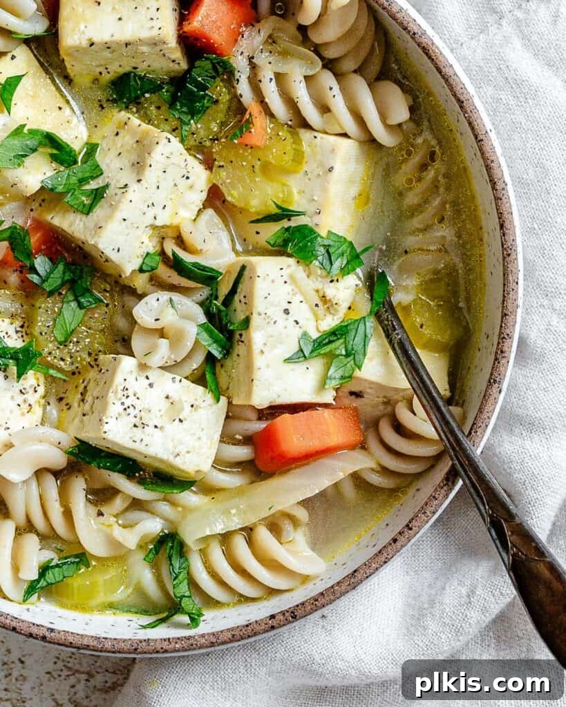 Vegan Chicken Noodle Soup: Stovetop, Instant Pot, and Slow Cooker 13 bowl of completed cooked soup on a white surface