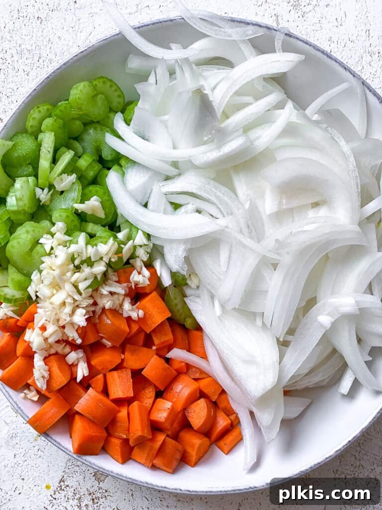 Vegan Chicken Noodle Soup: Stovetop, Instant Pot, and Slow Cooker 4 sliced vegetables on a white surface