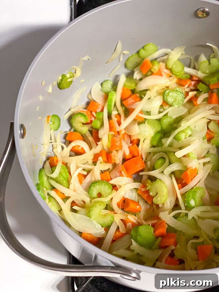 Vegan Chicken Noodle Soup: Stovetop, Instant Pot, and Slow Cooker 7 process shot of veggies cooking in a pot