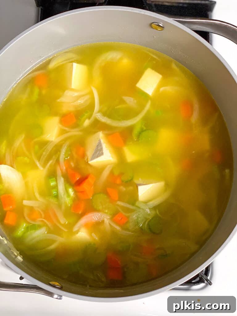 Vegan Chicken Noodle Soup: Stovetop, Instant Pot, and Slow Cooker 10 process shot of soup cooking in a pot
