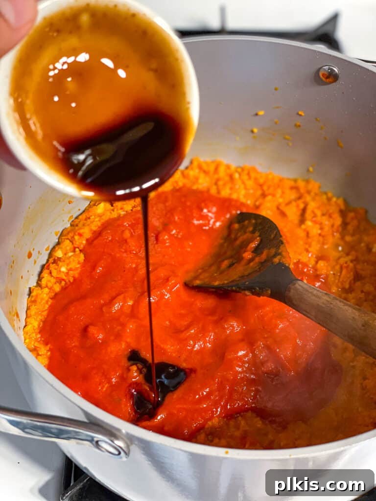 Hearty Lentil Sloppy Joes for Stove Top or Slow Cooker 11 Process shot of stirring various sauces into the vegetable mixture.