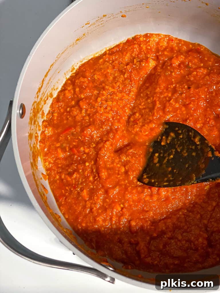 Hearty Lentil Sloppy Joes for Stove Top or Slow Cooker 13 Process shot of mixing all the sauce ingredients together thoroughly.
