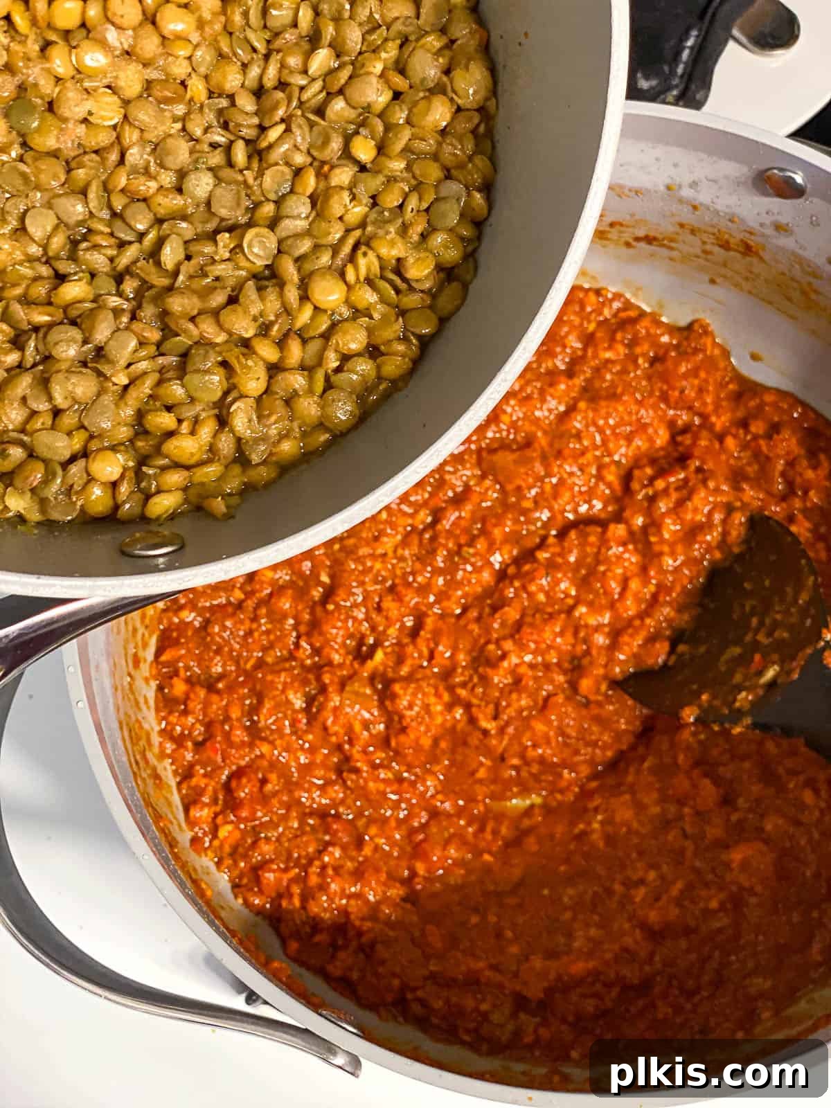Hearty Lentil Sloppy Joes for Stove Top or Slow Cooker 14 Process shot of adding cooked lentils to the simmering sloppy joe sauce.