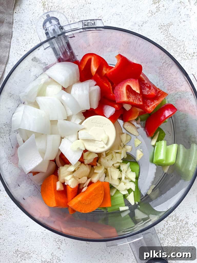 Hearty Lentil Sloppy Joes for Stove Top or Slow Cooker 7 Process shot of chopped vegetables in a food processor, ready to be blended.