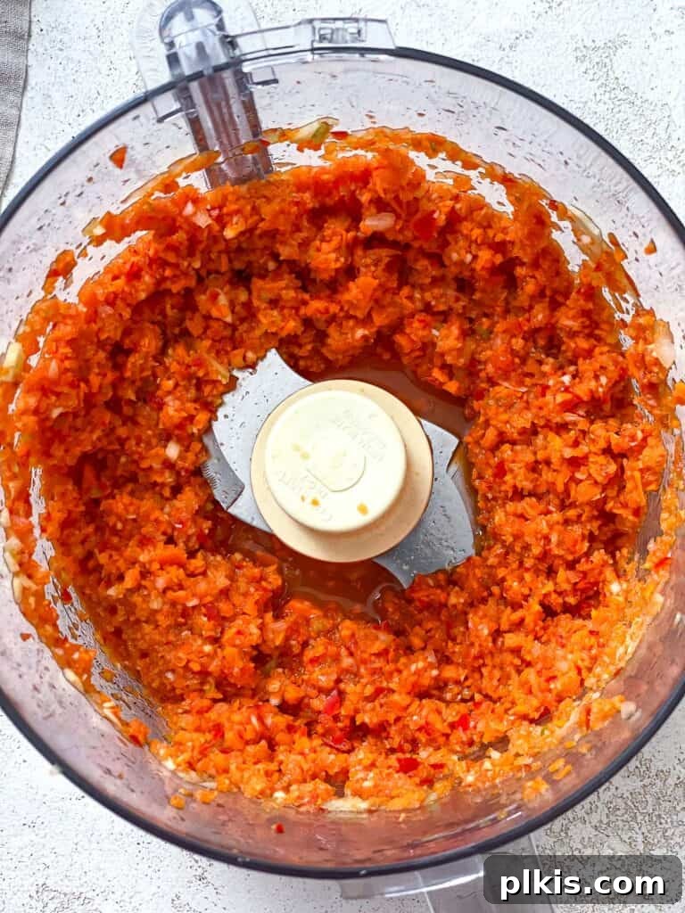 Hearty Lentil Sloppy Joes for Stove Top or Slow Cooker 8 Process shot of vegetables being blended to a fine chop in a food processor.