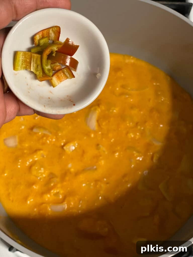 Golden Thai Squash Elixir 13 Thai bird chiles being added to the soup mixture in a blender, ready for pureeing.