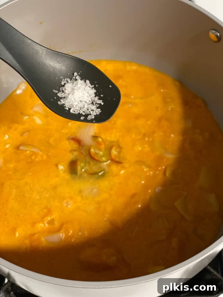 Golden Thai Squash Elixir 15 A sprinkle of kosher salt being added to the soup in the blender for seasoning.