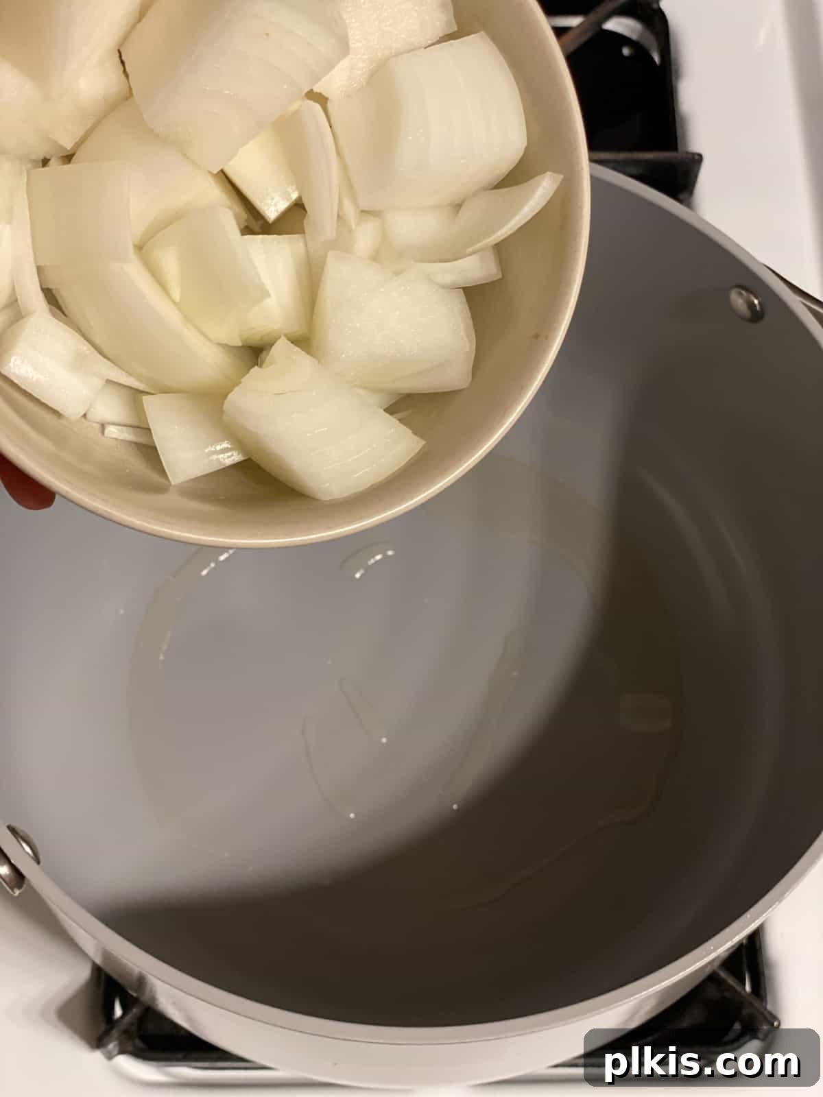 Golden Thai Squash Elixir 9 Chopped onions simmering in oil in a pot over medium-high heat, becoming translucent.