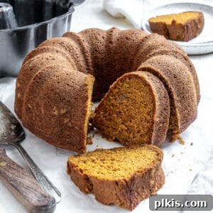 completed Easy Pumpkin Bundt Cake on a white surface, ready to be enjoyed.
