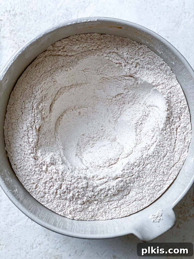 All dry ingredients for the Vegan Pumpkin Bundt Cake thoroughly mixed in a bowl, ready for the addition of wet ingredients.