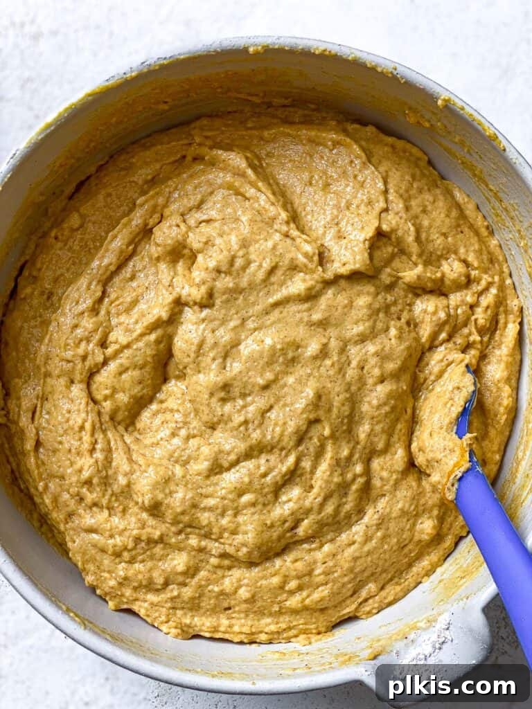 Vegan Pumpkin Bundt Cake batter freshly mixed in a bowl, showcasing its smooth and consistent texture before baking.