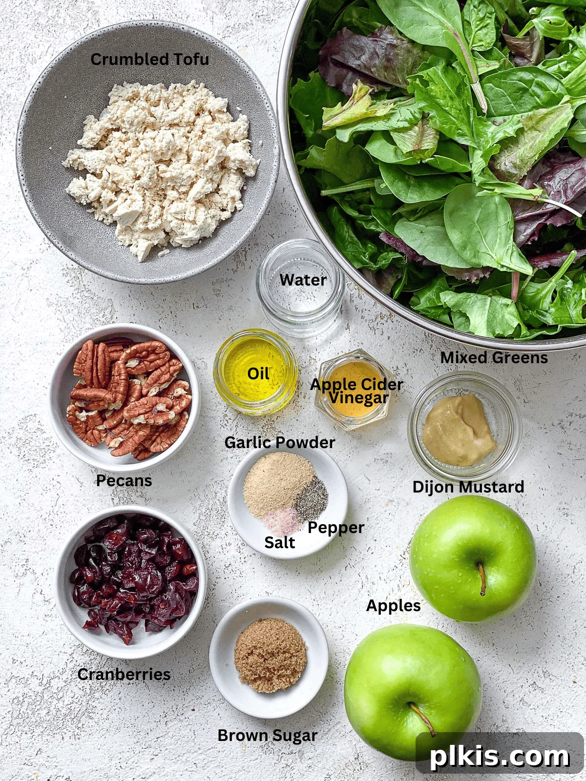 Crisp Apple Pecan Cranberry Salad 3 Carefully measured ingredients for an Easy Apple Pecan Salad with Cranberries laid out on a clean white surface.