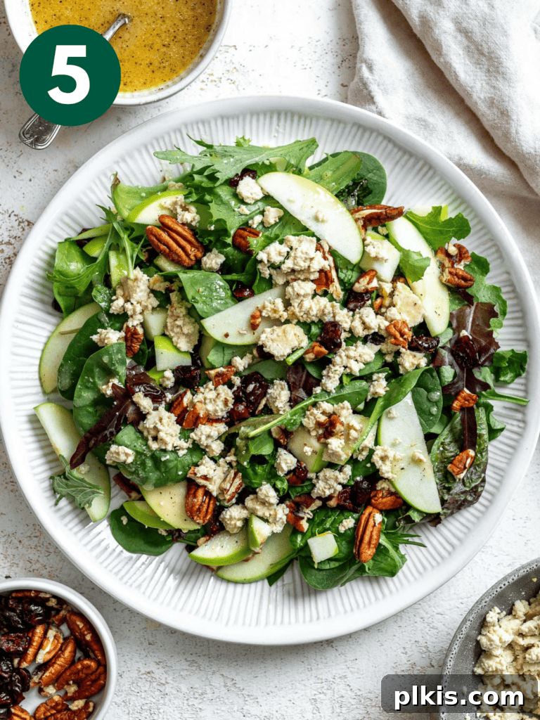 Crisp Apple Pecan Cranberry Salad 8 A vibrant and completed Easy Apple Pecan Salad with Cranberries in a beautifully presented bowl.