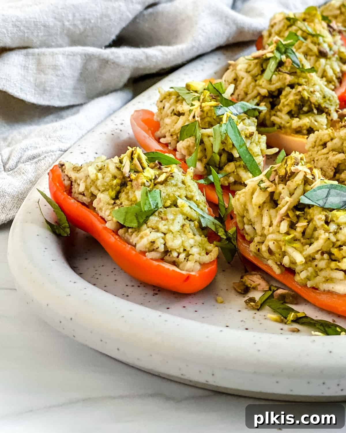 Savory Stuffed Roasted Sweet Peppers 2 finished Stuffed Roasted Sweet Peppers plated on a white tray