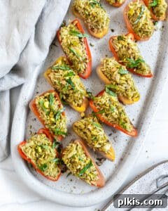 Savory Stuffed Roasted Sweet Peppers 7 finished Stuffed Roasted Sweet Peppers plated on a white tray