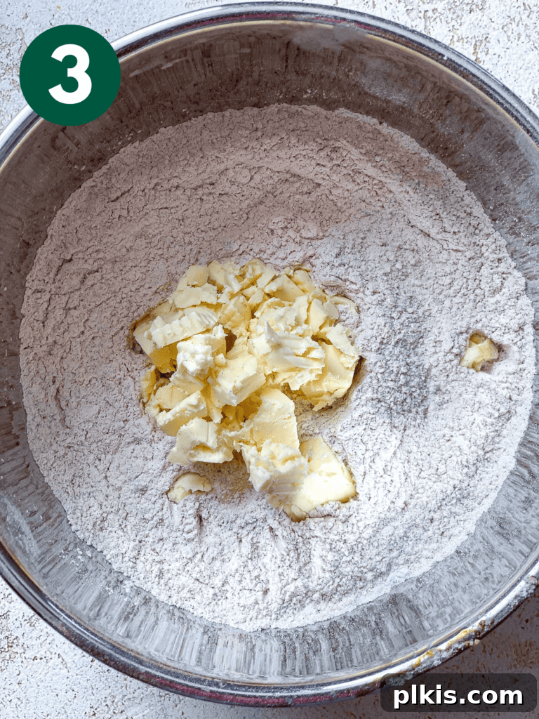 Fluffy Autumn Spiced Vegan Pumpkin Scones 6 process shot of adding vegan butter to bwol