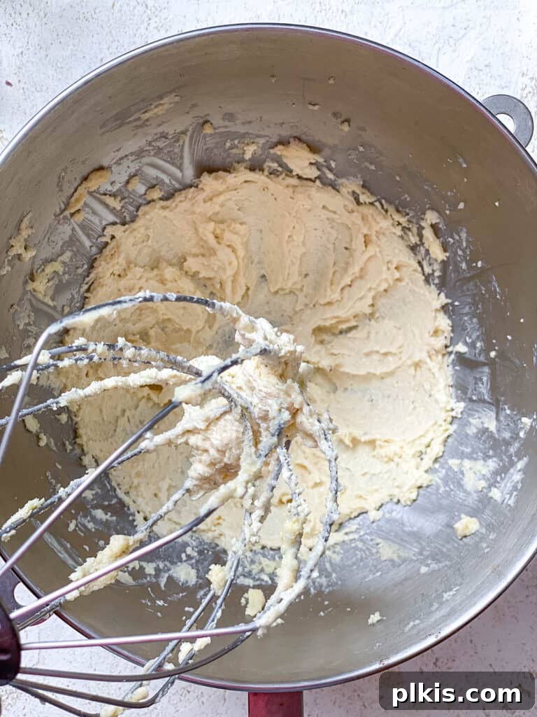 Cozy Vegan Gingerbread Spice Cake 5 A process shot showing vegan butter and sugar being creamed together in a mixing bowl with an electric mixer.