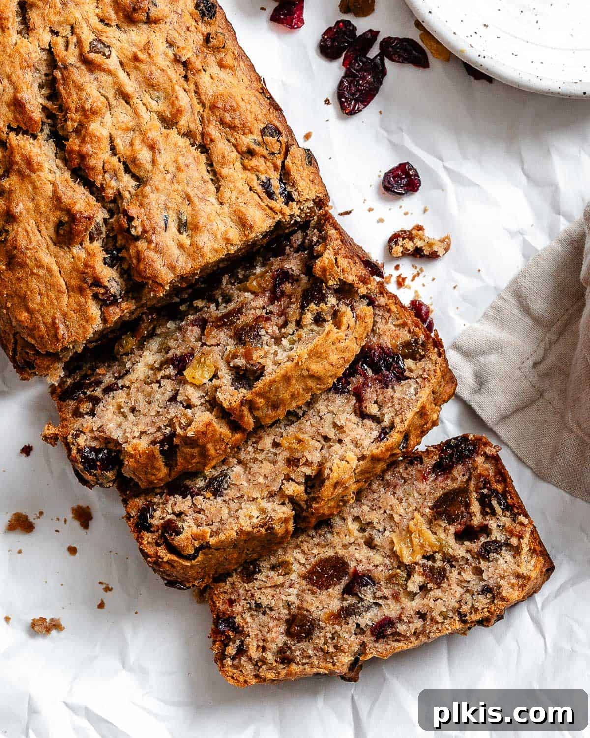 Beautifully baked Vegan Fruit Cake [Fruit Loaf] presented on a pristine white surface, ready to be enjoyed.