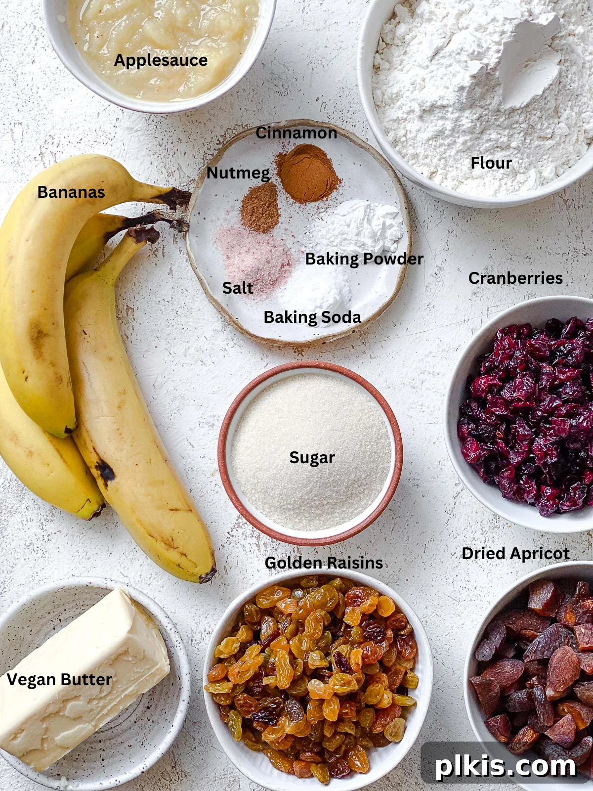 A selection of fresh ingredients neatly arranged on a white surface, ready for preparing Vegan Fruit Cake [Fruit Loaf].
