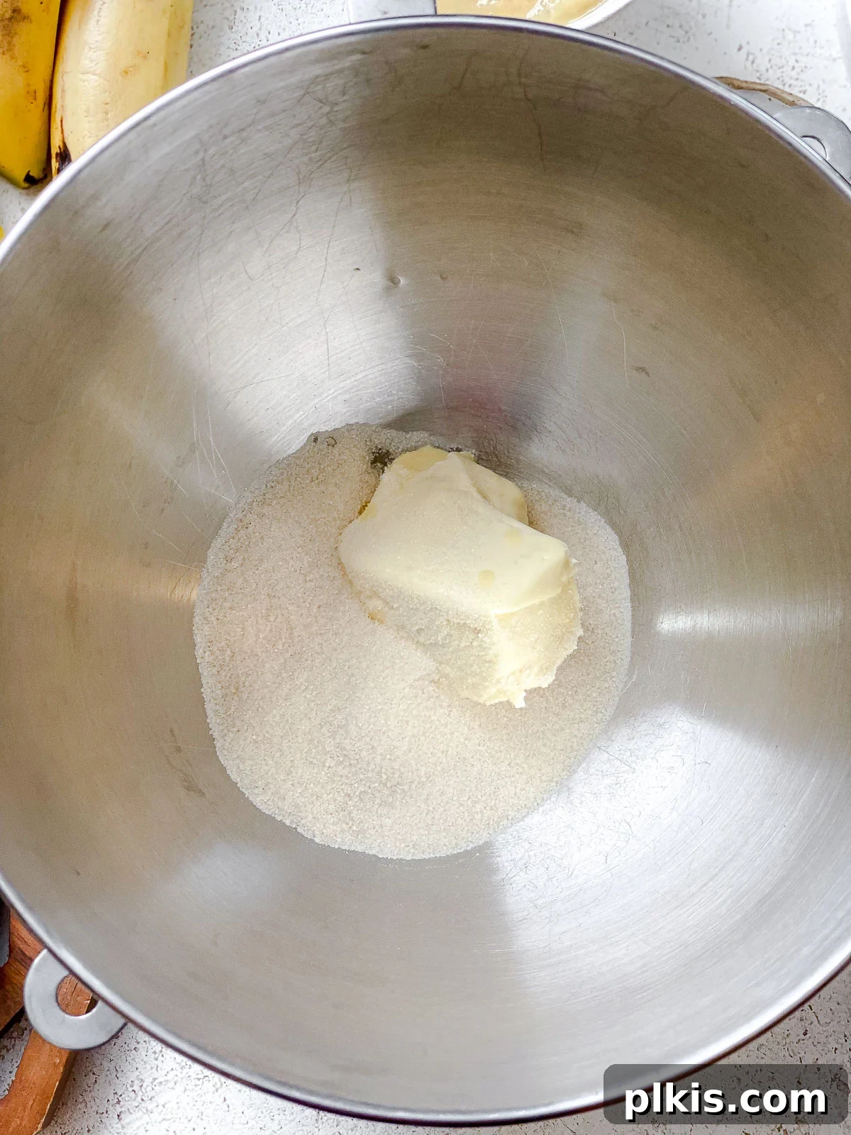 Hearty Vegan Fruit Loaf 4 Process shot showing vegan butter and sugar being creamed together in a mixing bowl, creating a light and fluffy mixture.