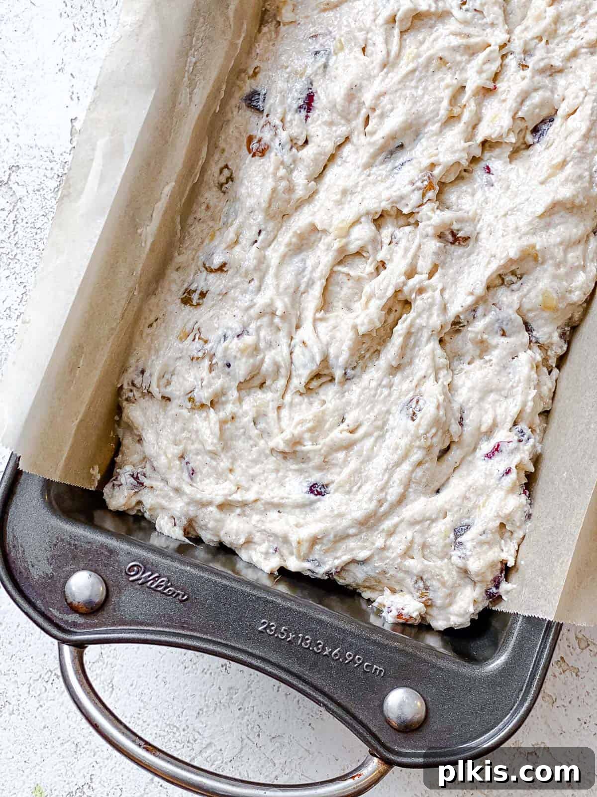 Hearty Vegan Fruit Loaf 7 Process shot showing the prepared fruit cake batter neatly poured into a loaf pan, ready for baking in the oven.