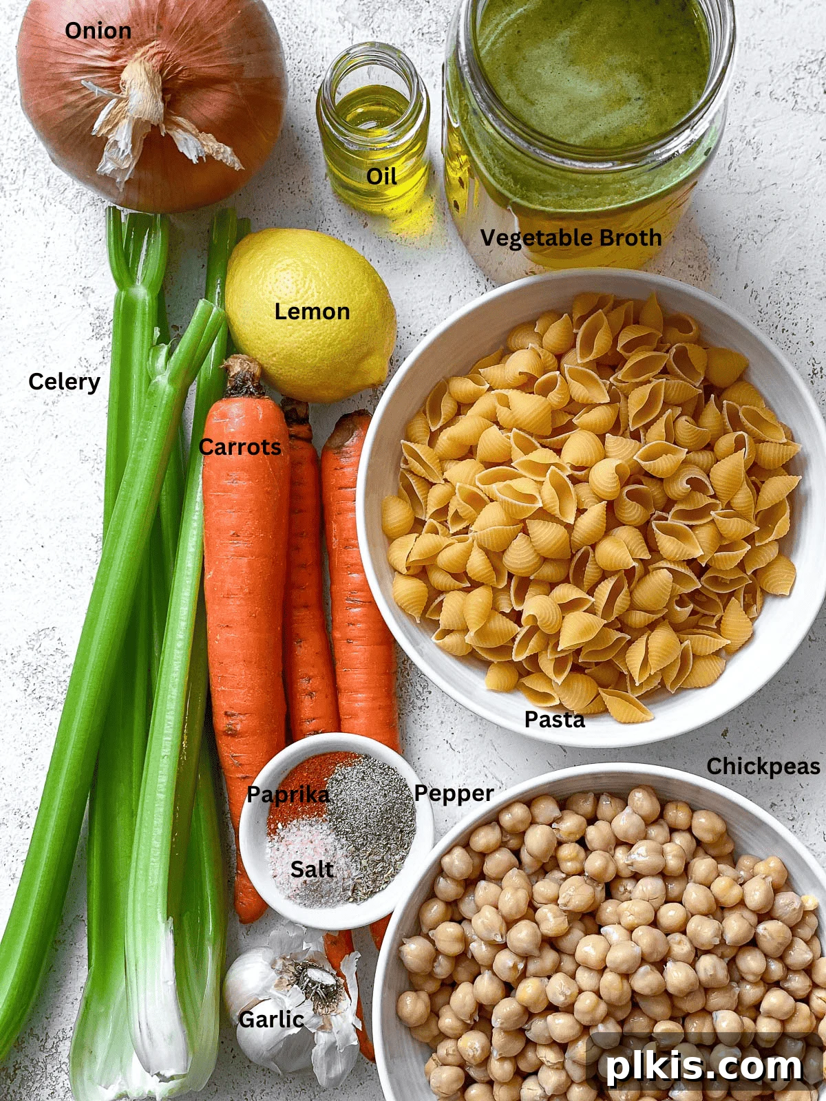 Comforting Vegan Chickpea Noodle Soup 3 A vibrant selection of fresh ingredients laid out for making chickpea noodle soup, including vegetables, spices, chickpeas, and pasta.