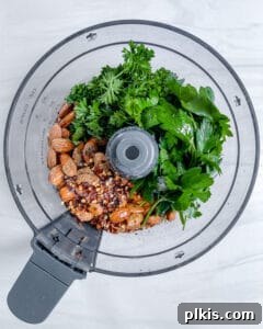 Fresh Parsley Potatoes 6 Process image showing the parsley, almonds, and other dressing ingredients in a food processor, ready to be blended.