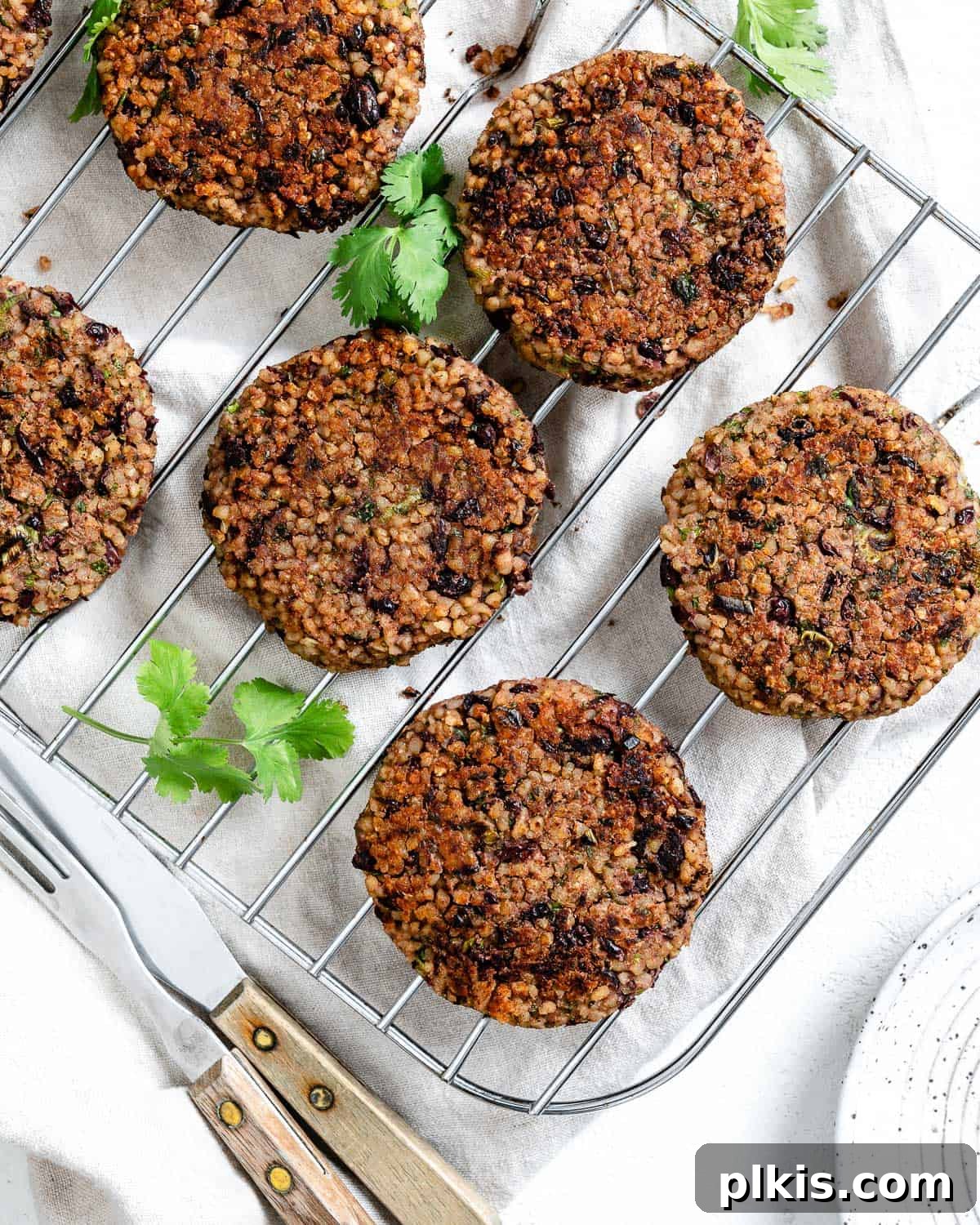 Hearty Vegan Black Bean and Bulgur Burgers 2 completed Vegan Black Bean and Bulgur Burgers on a wire rack against a light surface
