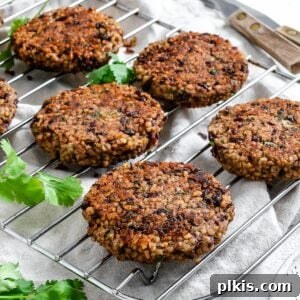 Hearty Vegan Black Bean and Bulgur Burgers 11 completed Vegan Black Bean and Bulgur Burgers on a wire rack against a light surface