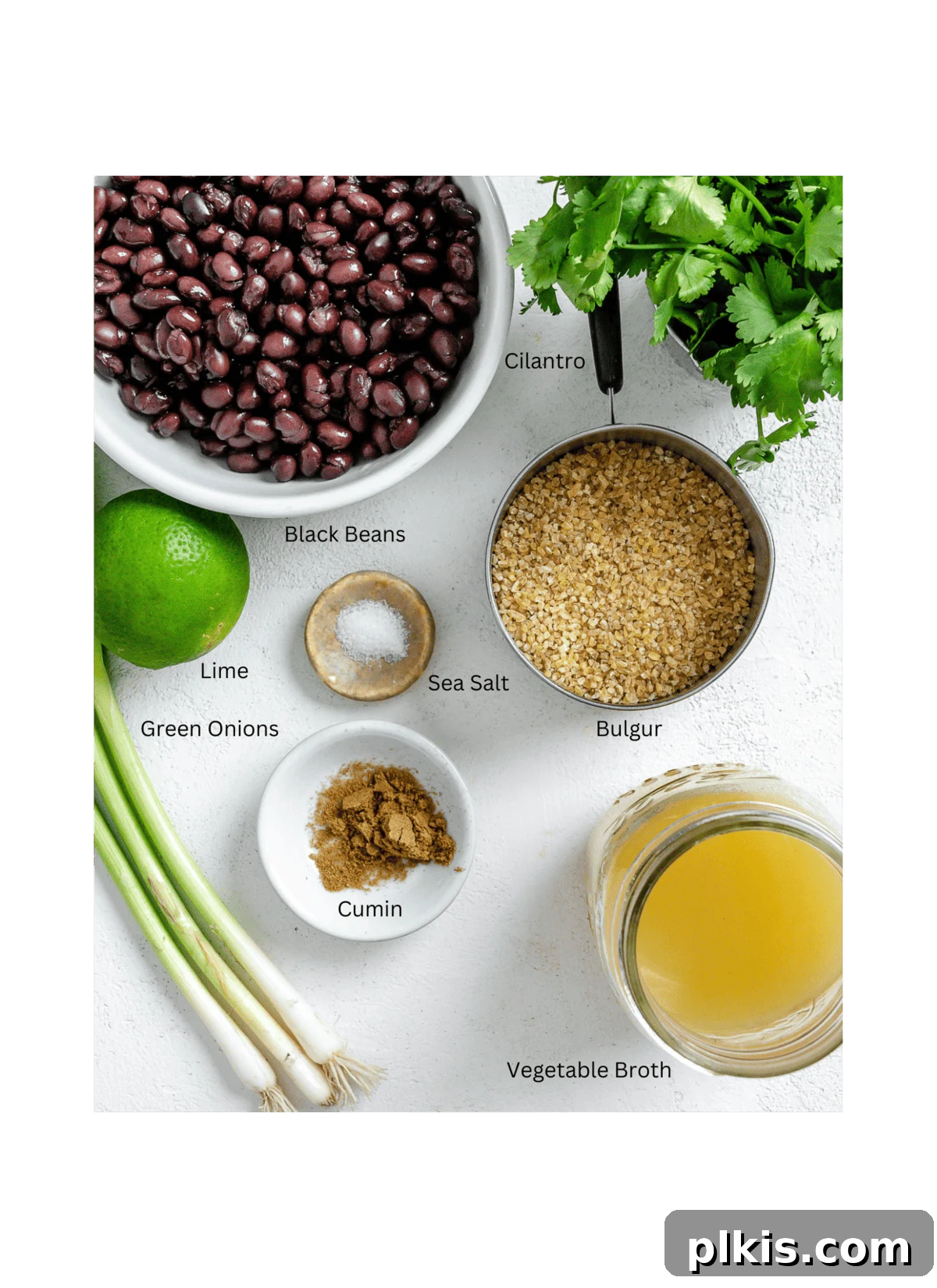 Hearty Vegan Black Bean and Bulgur Burgers 3 ingredients for Vegan Black Bean and Bulgur Burgers measured out against a white surface