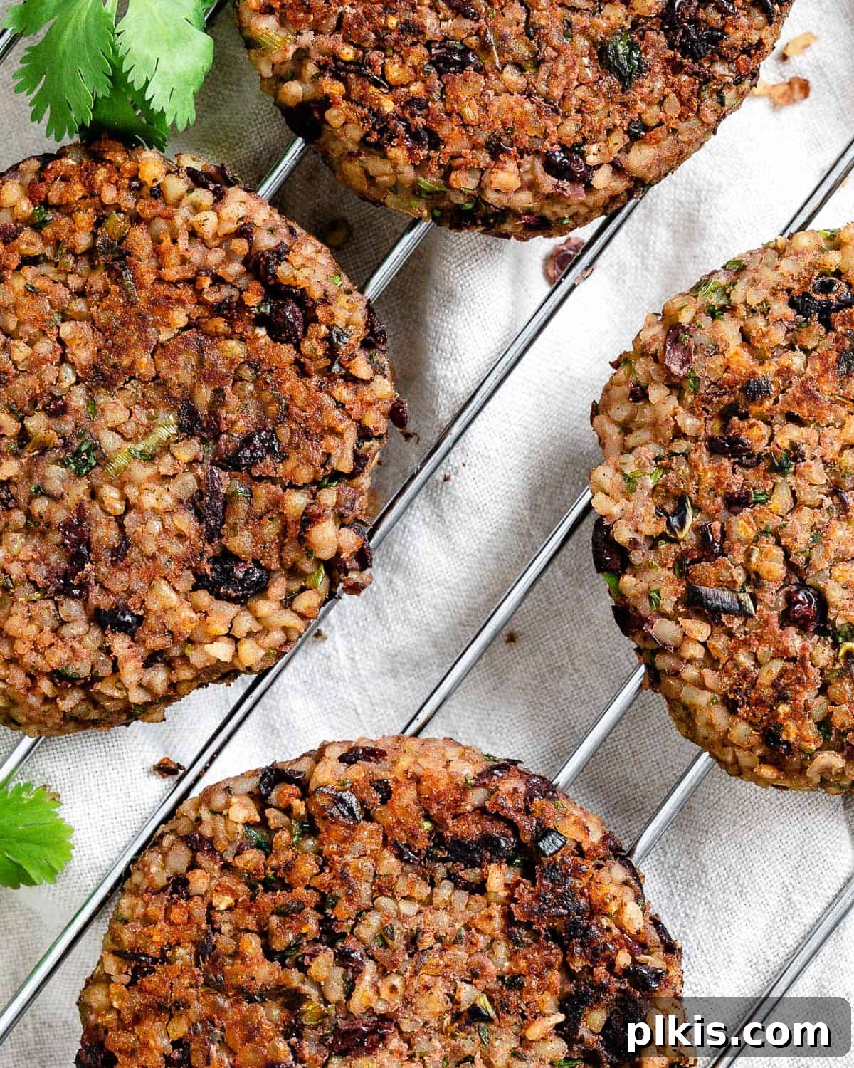Hearty Vegan Black Bean and Bulgur Burgers 9 completed Vegan Black Bean and Bulgur Burgers on a wire rack against a light surface