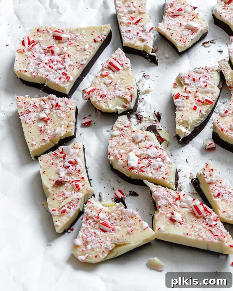 Completed Vegan Peppermint Bark on a white surface, showcasing its two layers and crushed peppermint candy topping.