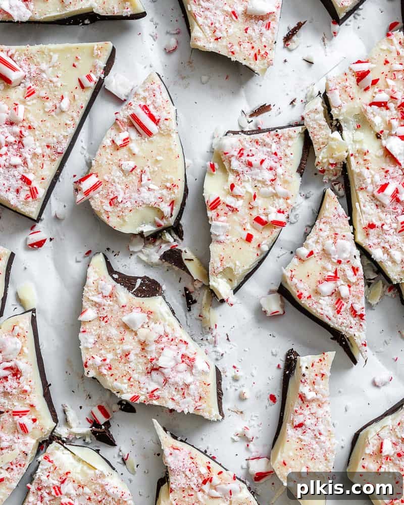Close-up of completed Vegan Peppermint Bark on a white surface, showing the crisp edges and festive topping.