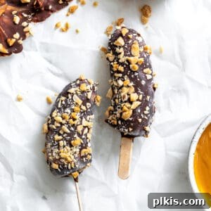 completed Peanut Butter and Chocolate Covered Bananas on a white surface