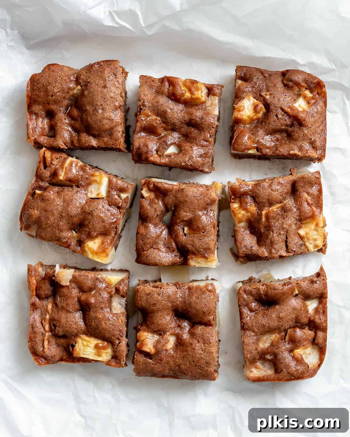 Plant-Based Pear Bliss 2 completed Vegan Pear Cake slices on a white surface, showcasing its moist texture and pear pieces