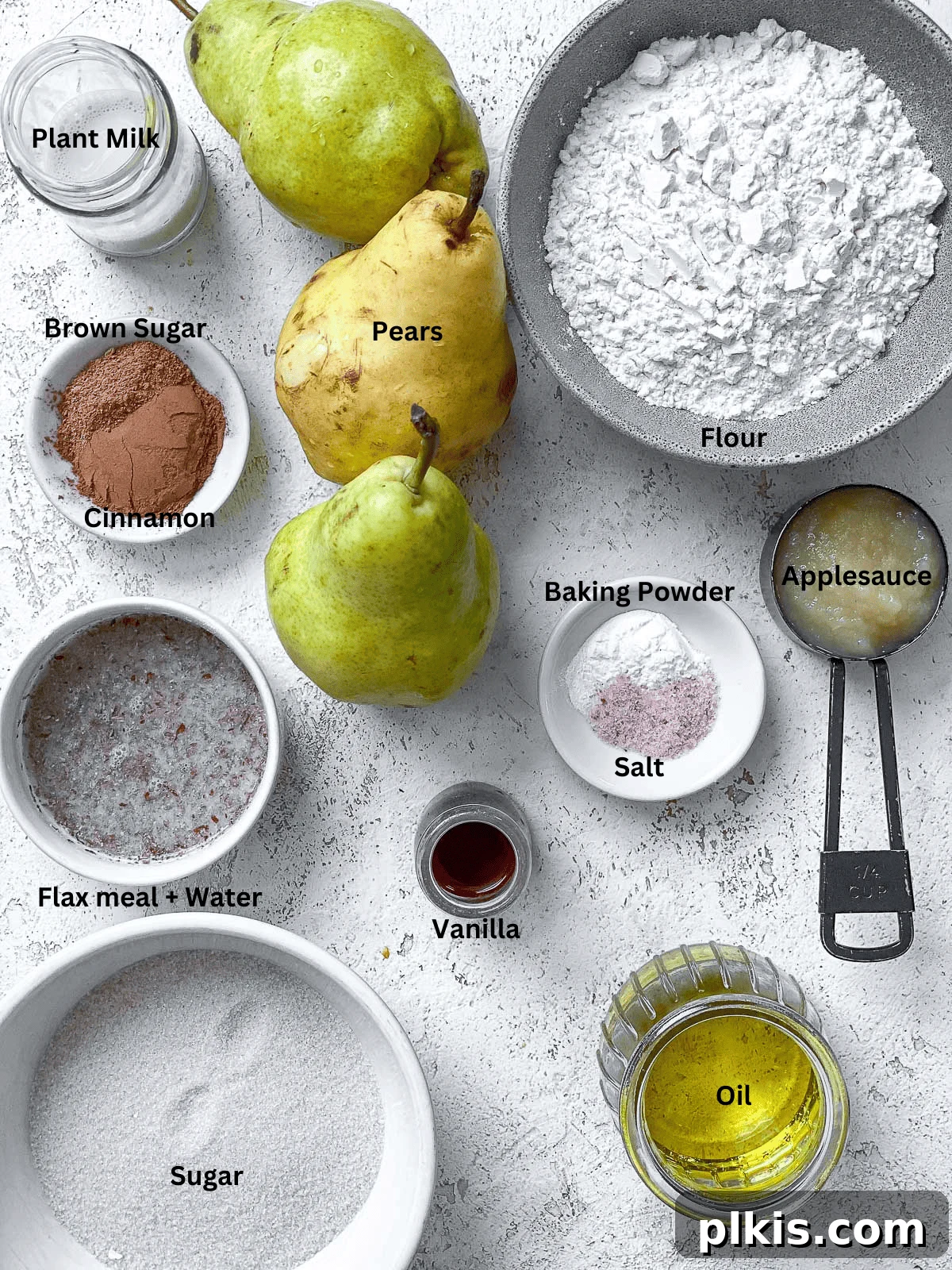 Plant-Based Pear Bliss 3 ingredients for Vegan Pear Cake artfully arranged on a white surface