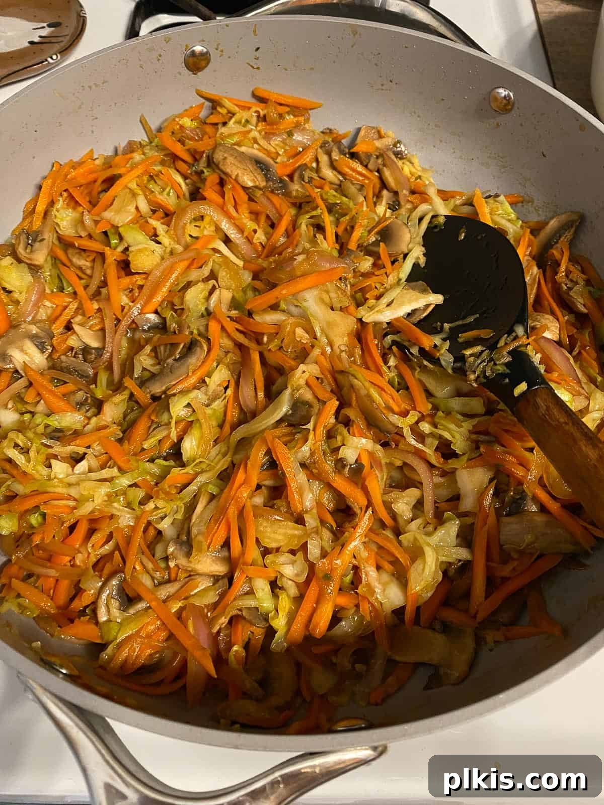Vibrant Moo Shu Medley 11 A process shot illustrating the mixing of ingredients in the pan, ensuring all vegetables are coated with the delicious Moo Shu Vegetable sauce.