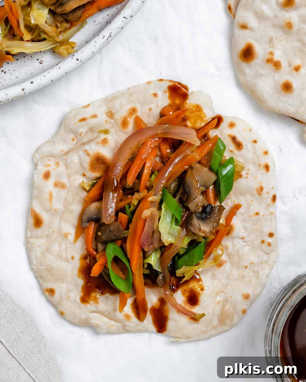 Vibrant Moo Shu Medley 14 A vibrant close-up of finished Moo Shu Vegetables, artfully arranged on delicate mandarin pancakes, showcasing the delicious textures and colors of the dish.